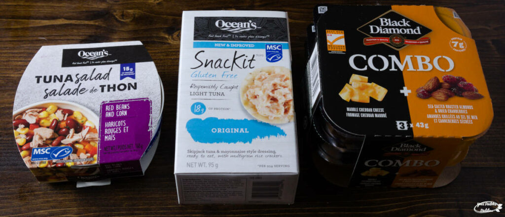 Three packaged snack examples. Two tuna snacks containing either beans or crackers, and one containing cheese, nuts and dried fruit