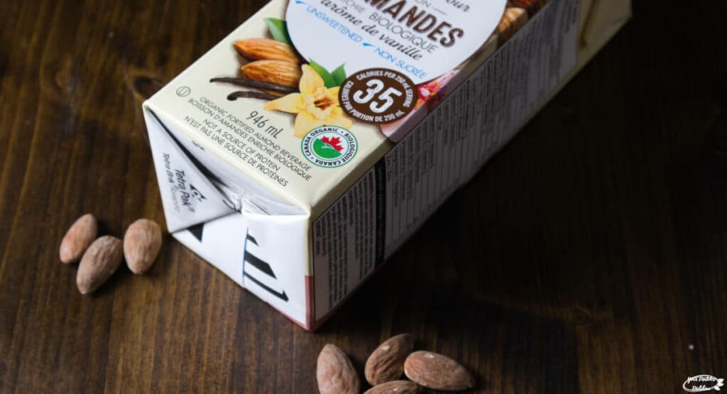 A box of almond milk and some almonds