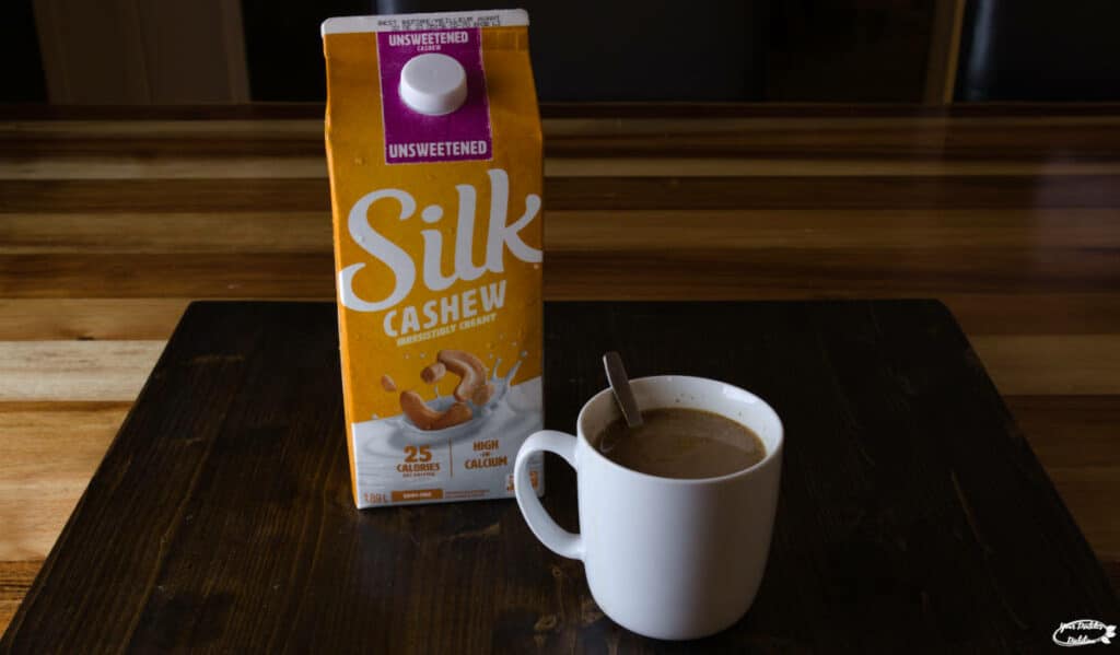A mug of coffee with Silk Cashew milk for creamer