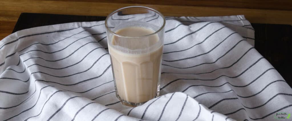 A glass of a protein shake on a cloth.